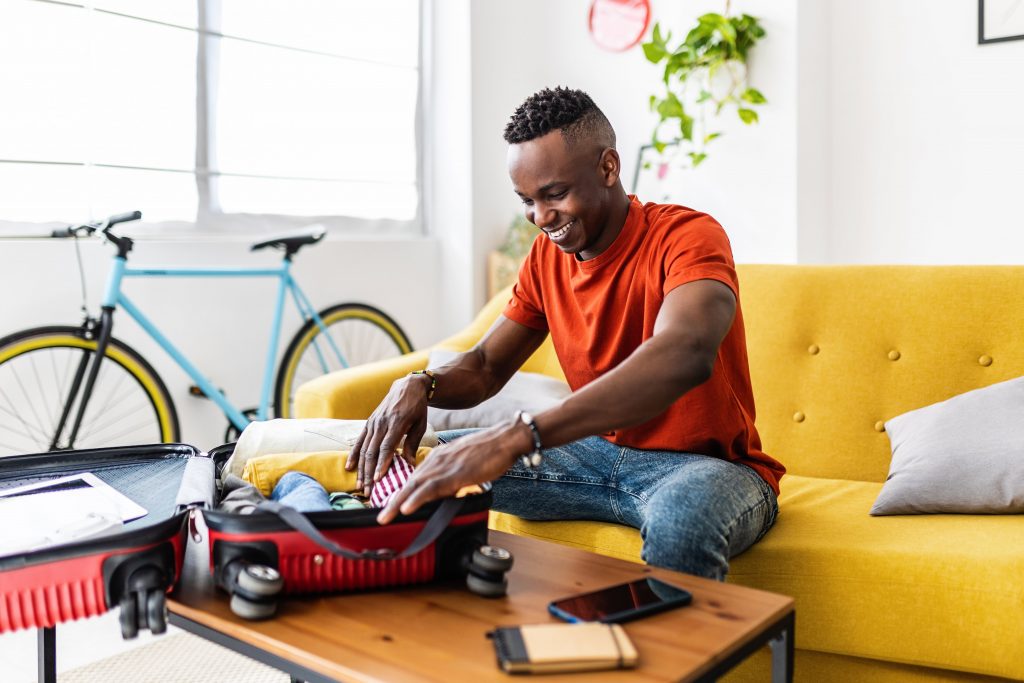 black man starting to pack for a spring holiday